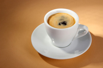 Cup of coffee on beige background