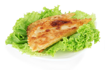 Tasty chebureks with fresh herbs on plate, close-up