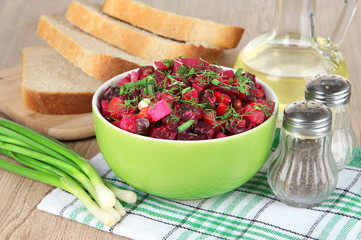 Beet salad in bowl on table close-up