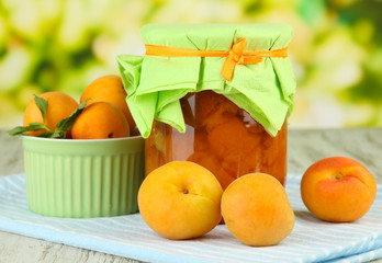 Apricot jam in glass jar and fresh apricots,