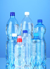 Bottles of water, on blue background