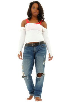 Beautiful black woman in torn jeans and white shirt standing on
