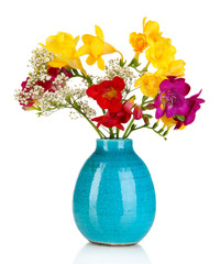 Beautiful bouquet of freesia in blue vase isolated on white