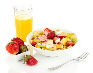 Useful fruit salad of fresh fruits and berries in bowl isolated