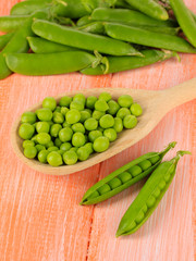 Sweet green peas on wooden background