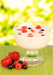 Delicious yogurt with fruit on table on bright background