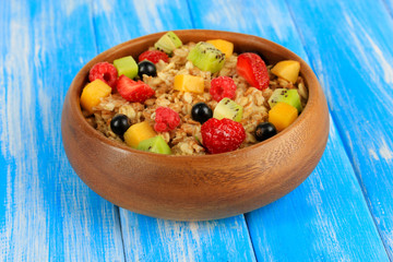 Oatmeal with fruits on table close-up