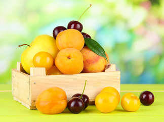 Bright summer fruits in wooden box
