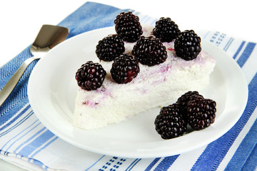 Cheesecake with fresh berries on white plate closeup