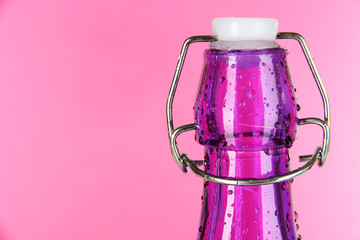 Colorful bottle on pink background