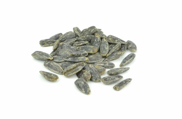A pile of dry roasted sunflower seeds on a white background