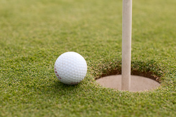 Golf ball on green grass, selective focus