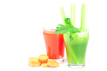 glass of celery juice and a glass of carrot juice isolated on wh
