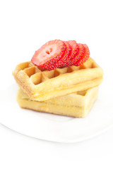 Belgian waffles and strawberry on a plate isolated on white