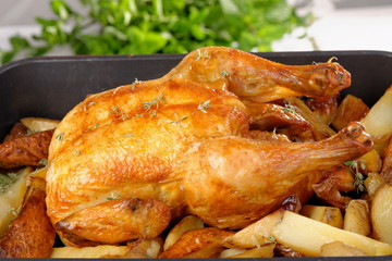 Roasted chicken and potato on white background