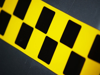 Line with black and yellow taxi sign on the car