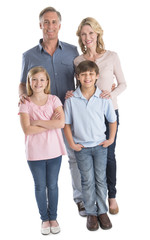 Happy Family Of Four Smiling Against White Background