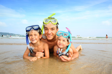 Portrait of father and children wearing diving mask