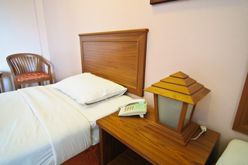 Fototapeta na wymiar bedroom with bedside wood table and lamp.
