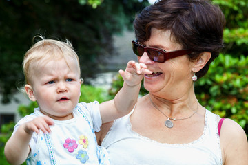 Happy mother holds daughter on the arm