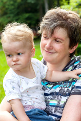 Happy mother holds daughter on the arm