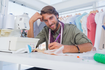 Happy designer working at his desk