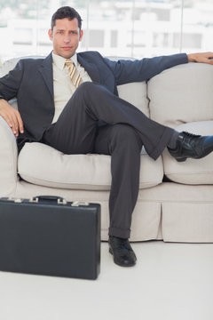 Businessman sitting with legs crossed on the couch