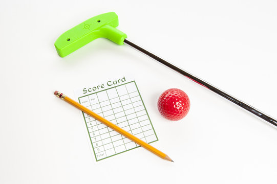 Green mini golf club with score card and ball