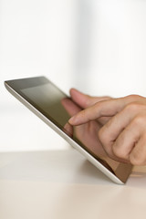 Man hand touching screen on digital tablet pc. Close-up.