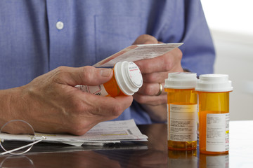 Older man with prescription medications, horizontal