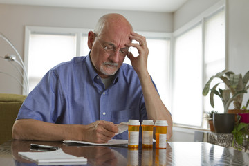 Older man with prescription medications, horizontal - obrazy, fototapety, plakaty