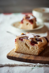 Homemade cake with raspberries on kitchen board