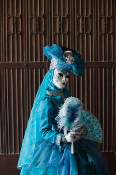 The blue lady in the carnivalesque costume  and venetian mask