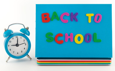 Back to school concept. Alarm clock,  notebook  and pencil
