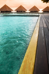 Over water bungalows with steps into amazing green lagoon