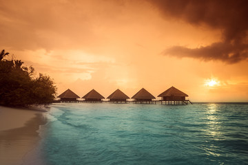 Over water bungalows with steps into amazing green lagoon