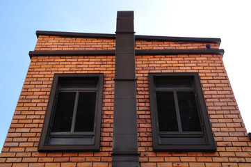 Red brick wall with classic windows, European style.
