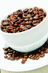 roasted coffee beans in a white cup