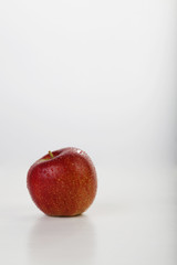 wet red apple isolated on white