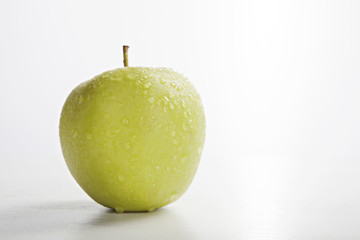 wet green apple isolated on white