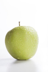 wet green apple isolated on white