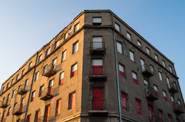 Fototapeta premium Old abandoned building with white and red windows