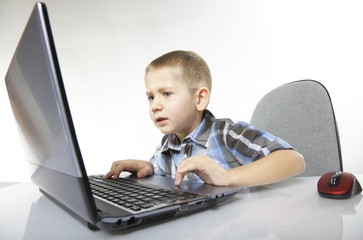 Computer addiction emotional boy with laptop