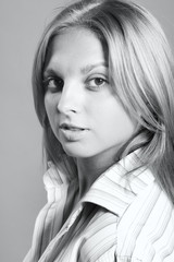 Head shot of young attractive blonde in striped white shirt