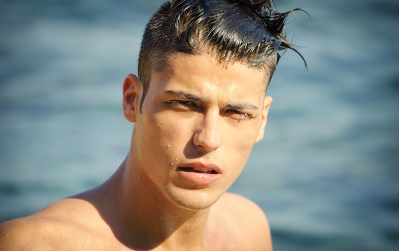 Handsome Young Man Getting Out Of Water With Wet Hair