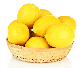 Ripe lemons in wicker basket isolated on white
