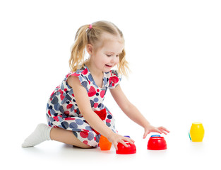 girl child playing with cup toys, isolated over white
