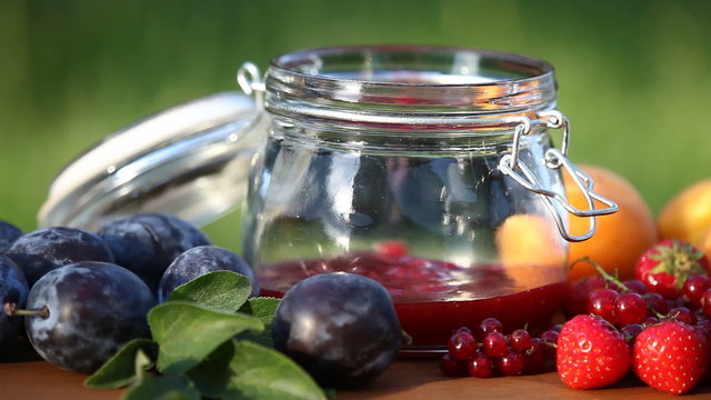 Jar with fresh jam and fruits