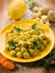 gnocchi with ricotta carrot and lemon peel, selective focus