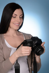 Her new hobby. Beautiful middle-aged women holding camera while